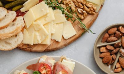 an assorted food on a charcuterie board and ceramic plate